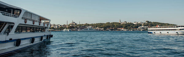 Ships on water with city at background in Istanbul, Turkey, banner 