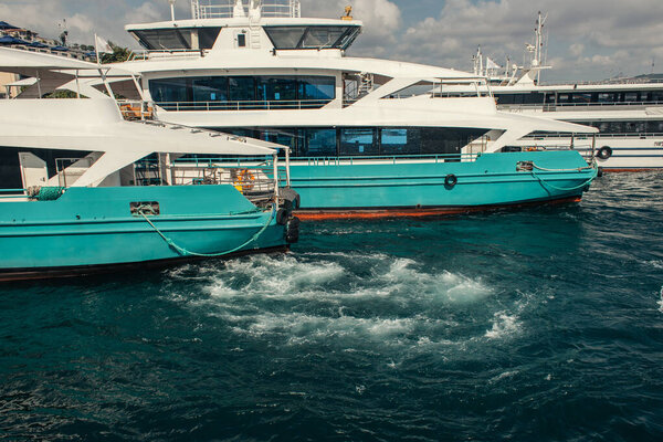 Yachts on water near city in Istanbul, Turkey 