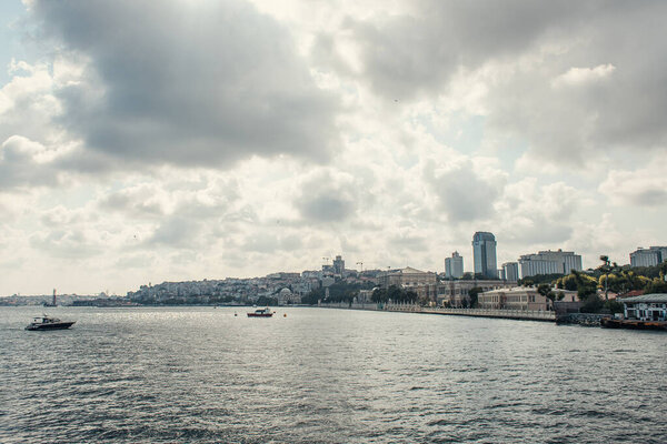 Ships in sea near seafront with cloudy sky at background, Istanbul, Turkey 