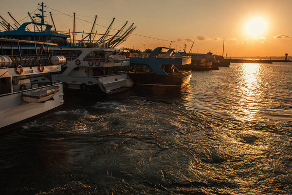 Boats on sea water with sun in sky during sunset, Istanbul, Turkey 