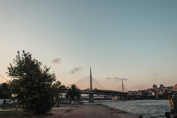 View of Golden horn metro bridge and sea during sunset in Istanbul, Turkey 