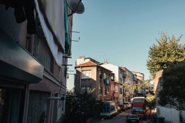 ISTANBUL, TURKEY - NOVEMBER 12, 2020: narrow street with vehicles in Balat quarter clipart