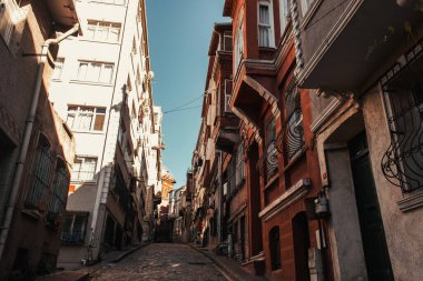 narrow street with contemporary and old buildings in Balat, Istanbul, Turkey clipart