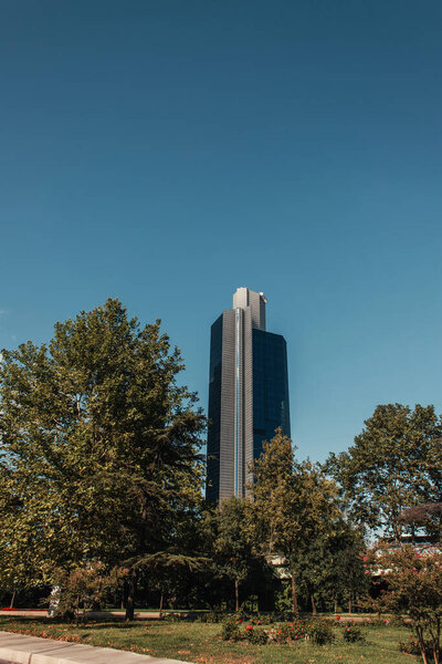 contemporary, multistorey building near green trees in Istanbul, Turkey