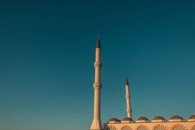 blue, cloudless sky over high minarets of Mihrimah Sultan Mosque, Istanbul, Turkey clipart