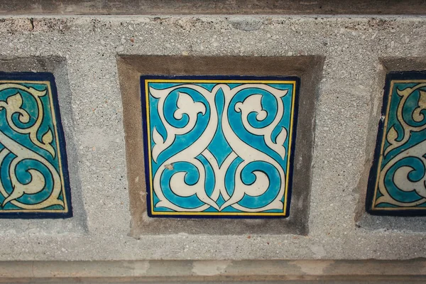 Close up view of mosaic with ornament on facade of building — Stock Photo