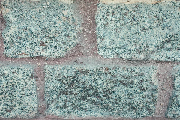 Pared de piedra de granito gris, sin pulir - foto de stock