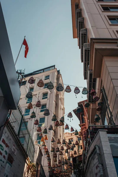 Low angle view of traditional wicker lanterns between houses in Balat, Istanbul, Turkey — Stock Photo