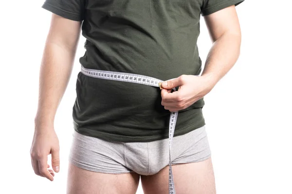 Non-Athletic man measures his waist with a centimeter — Stock Photo, Image