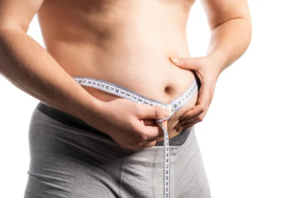 Not a sports man man measures his waist with a centimeter — Stock Photo, Image