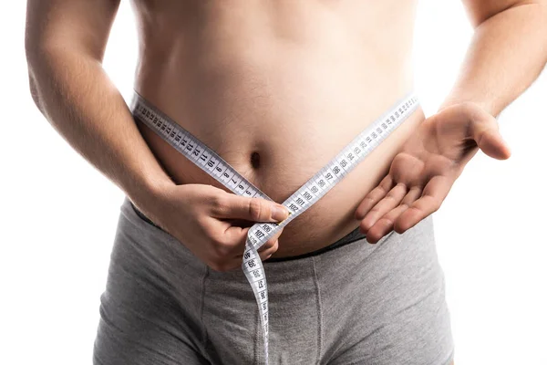 A man shows the result of measuring his waist with a centimeter — Stock Photo, Image