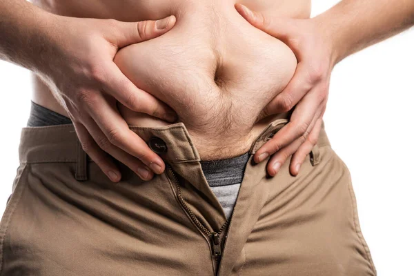 Male hands squeeze a bulging plump belly — Stock Photo, Image