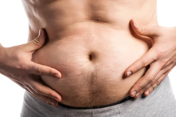 The man stuck out out his stomach and touches it with his hands — Stock Photo, Image