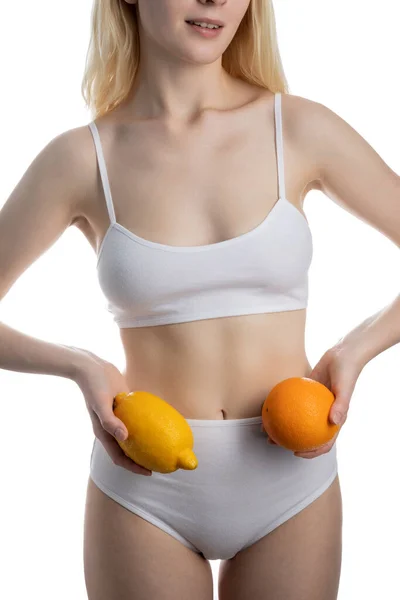 Girl holding citrus fruits at waist level — Stock Photo, Image