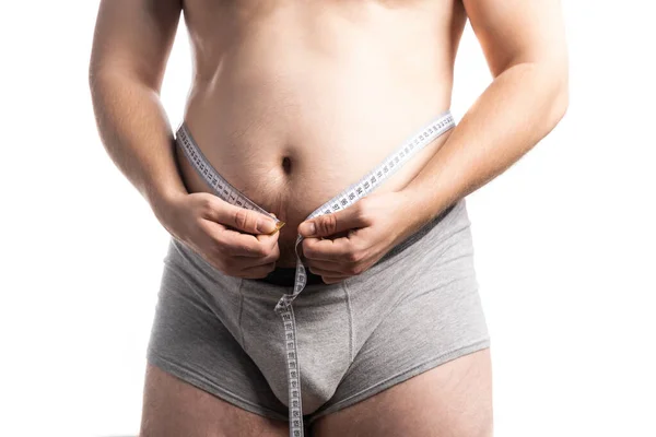 Homem medindo sua barriga gorda com fita métrica — Fotografia de Stock