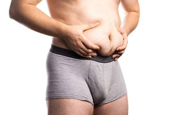 Close up of man grabbing his fat on the stomach — Stock Photo, Image