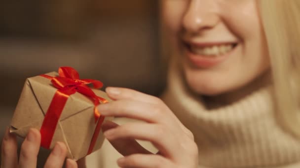 Womens hands take a red gift box, untie the ribbon. Concept of Holidays and Gifts — Stock Video