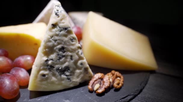 Cheese plate close-up with several varieties of fruit and honey cheese — Stock Video