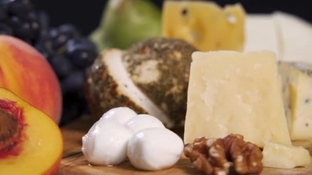 Cheese plate close-up with several varieties of fruit and honey cheese — Stock Video