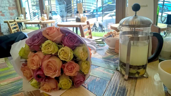 Rose multicolored bouquet on cafe table