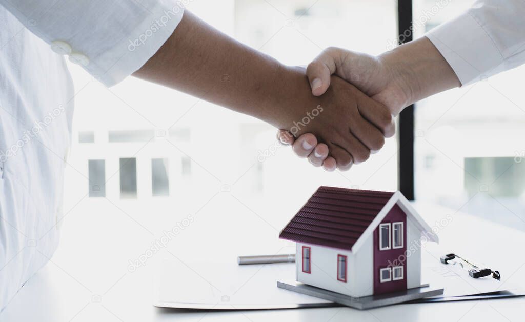 Property manager Shake hands with congratulations on the customers who bought the house with insurance, Hand shake, Success and congratulations concept.