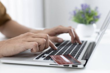 Erkekler internet üzerinden kredi kartı ödemelerini, teknoloji ve İnternet 'te rahatlığı, online alışveriş ve çevrimiçi bankacılık kavramını kullanarak çevrimiçi alışverişleri kaydetmek için dizüstü bilgisayar kullanıyorlar.