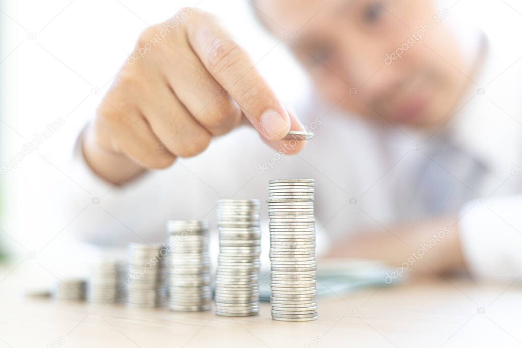 Financial business man with coins put in a jar, Saving money for future growth and knowing how to manage your spending wisely, Save money concept.