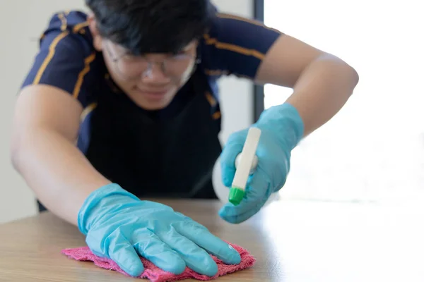 Close up Staff hand Restaurant workers are cleaning table and spraying disinfectants during the virus outbreak, Using cleaning solutions or using alcohol to kill germs in the restaurant.