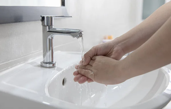 Men are washing their hands in the sinks to clear respiratory bacteria and viruses, sanitation and reduce the spread of COVID-19 that is spread around the world, Hygiene ,Sanitation concept.