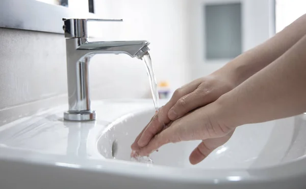 Men are washing their hands in the sinks to clear respiratory bacteria and viruses, sanitation and reduce the spread of COVID-19 that is spread around the world, Hygiene ,Sanitation concept.
