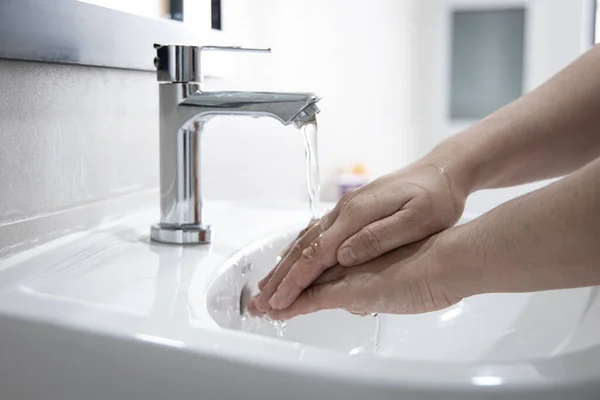 Men are washing their hands in the sinks to clear respiratory bacteria and viruses, sanitation and reduce the spread of COVID-19 that is spread around the world, Hygiene ,Sanitation concept.