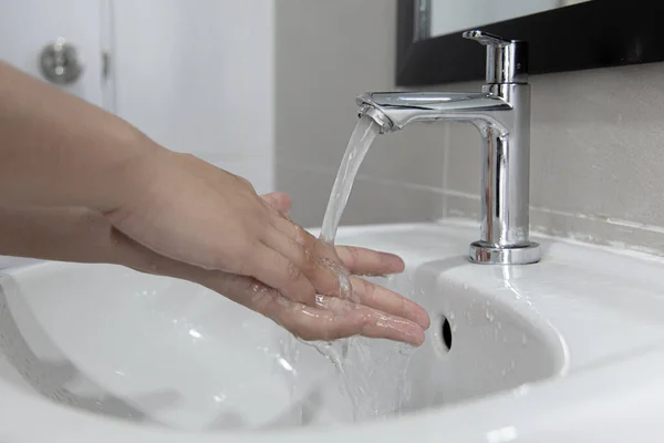 Men are washing their hands in the sinks to clear respiratory bacteria and viruses, sanitation and reduce the spread of COVID-19 that is spread around the world, Hygiene ,Sanitation concept.