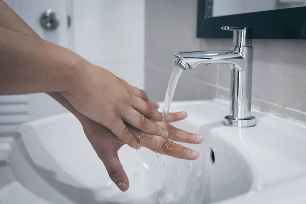 Men are washing their hands in the sinks to clear respiratory bacteria and viruses, sanitation and reduce the spread of COVID-19 that is spread around the world, Hygiene ,Sanitation concept.