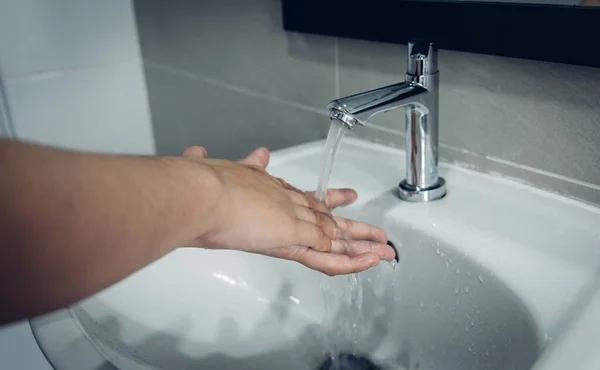 Men are washing their hands in the sinks to clear respiratory bacteria and viruses, sanitation and reduce the spread of COVID-19 that is spread around the world, Hygiene ,Sanitation concept.