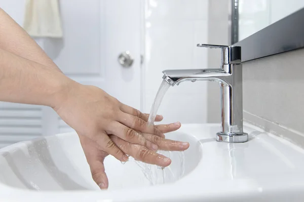 Men are washing their hands in the sinks to clear respiratory bacteria and viruses, sanitation and reduce the spread of COVID-19 that is spread around the world, Hygiene ,Sanitation concept.