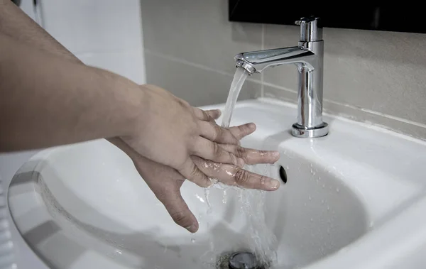 Men are washing their hands in the sinks to clear respiratory bacteria and viruses, sanitation and reduce the spread of COVID-19 that is spread around the world, Hygiene ,Sanitation concept.