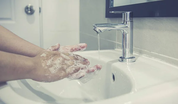 Men are washing their hands in the sinks to clear respiratory bacteria and viruses, sanitation and reduce the spread of COVID-19 that is spread around the world, Hygiene ,Sanitation concept.