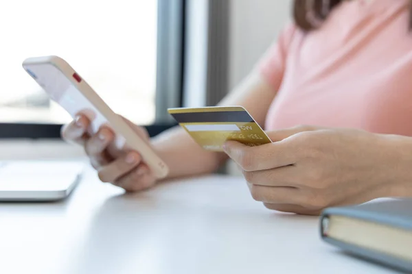 Businesswoman use mobile phones to register for security Online with a credit card to buy products online through application, Online shopping or Internet technology concept.