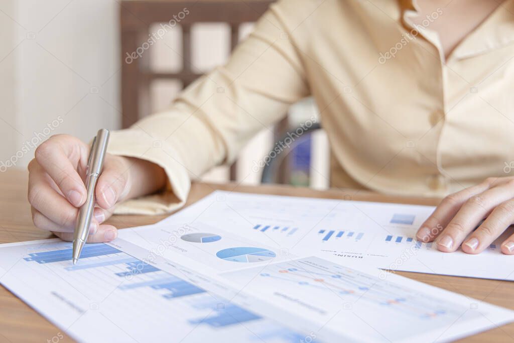 Financial businesswomen analyze the graph of the company's performance to create profits and growth, Market research reports and income statistics, Financial and Accounting concept.