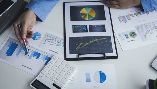 Financial businessman analyze the graph of the company\'s performance to create profits and growth, Market research reports and income statistics, Financial and Accounting concept.