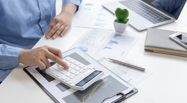 Financial businessman calculating corporate income tax data And analyzing charts of financial stocks that are in good condition with growth and progress, Investment in finance and accounting industries.
