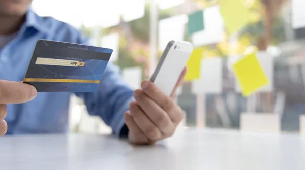 Businessman use mobile phones to register for security Online with a credit card to buy products online through application, Online shopping or Internet technology concept.