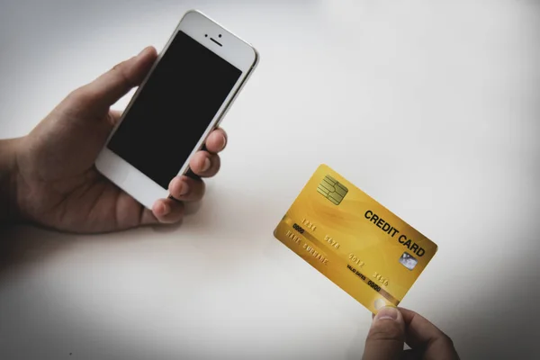 Businessman use mobile phones to register for security Online with a credit card to buy products online through application, Online shopping or Internet technology concept.