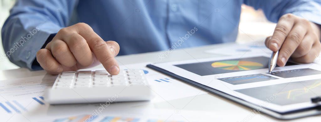 Financial businessman calculating corporate income tax data And analyzing charts of financial stocks that are in good condition with growth and progress, Investment in finance and accounting industries.