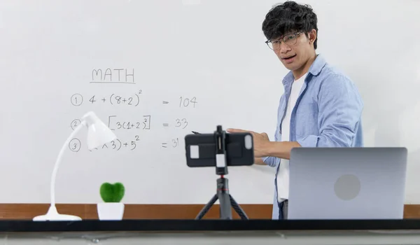 Asian university teachers are teaching mathematics with smart phone to record live on internet, Long-distance study due to the virus epidemic situation, Online remote learning, Quarantine for people.