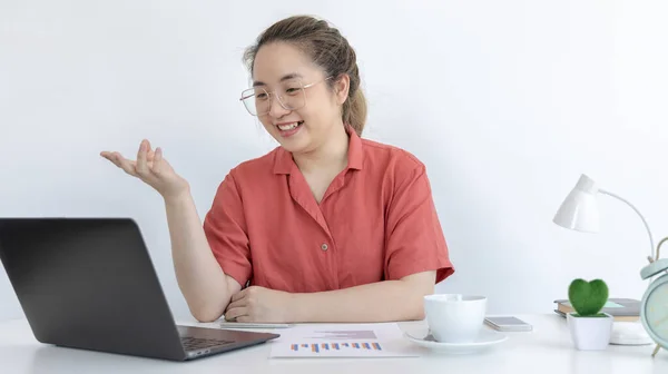 Young Asian women are greeting friends and teachers through video chats and greeting them with cheerful expressions, Online communication , Stay home, New normal, Covid-19 coronavirus, Social distancing, Internet learning.