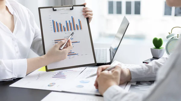 Brainstorm team, Marketers and financial accountants are discussing and analyzing charts to plan strategies to meet customer needs, Using graphs and laptops to analyze business data, Meeting concept.