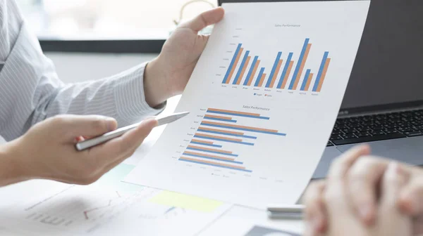 Brainstorm team, Marketers and financial accountants are discussing and analyzing charts to plan strategies to meet customer needs, Using graphs and laptops to analyze business data, Meeting concept.