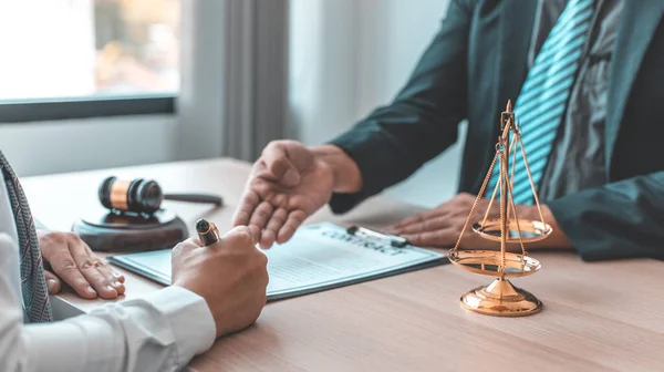 Lawyer or judge has recommend a client sign a legal agreement in the courtroom, Legal Agreement Documents and Business Litigation Forms, scales of justice, law hammer, Litigation and legal services.