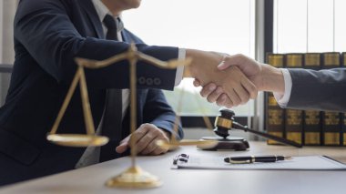 İş adamı, sözleşmeyi imzaladıktan sonra bir avukat ya da yargıçla el sıkışıyor ve anlaşma tamamlanıyor, iş ve hukuk arasındaki anlaşmanın onaylanması, dava sona eriyor..